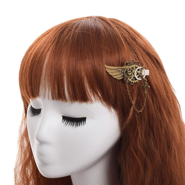 Mannequin head with red hair and decorative hair clip on a white background